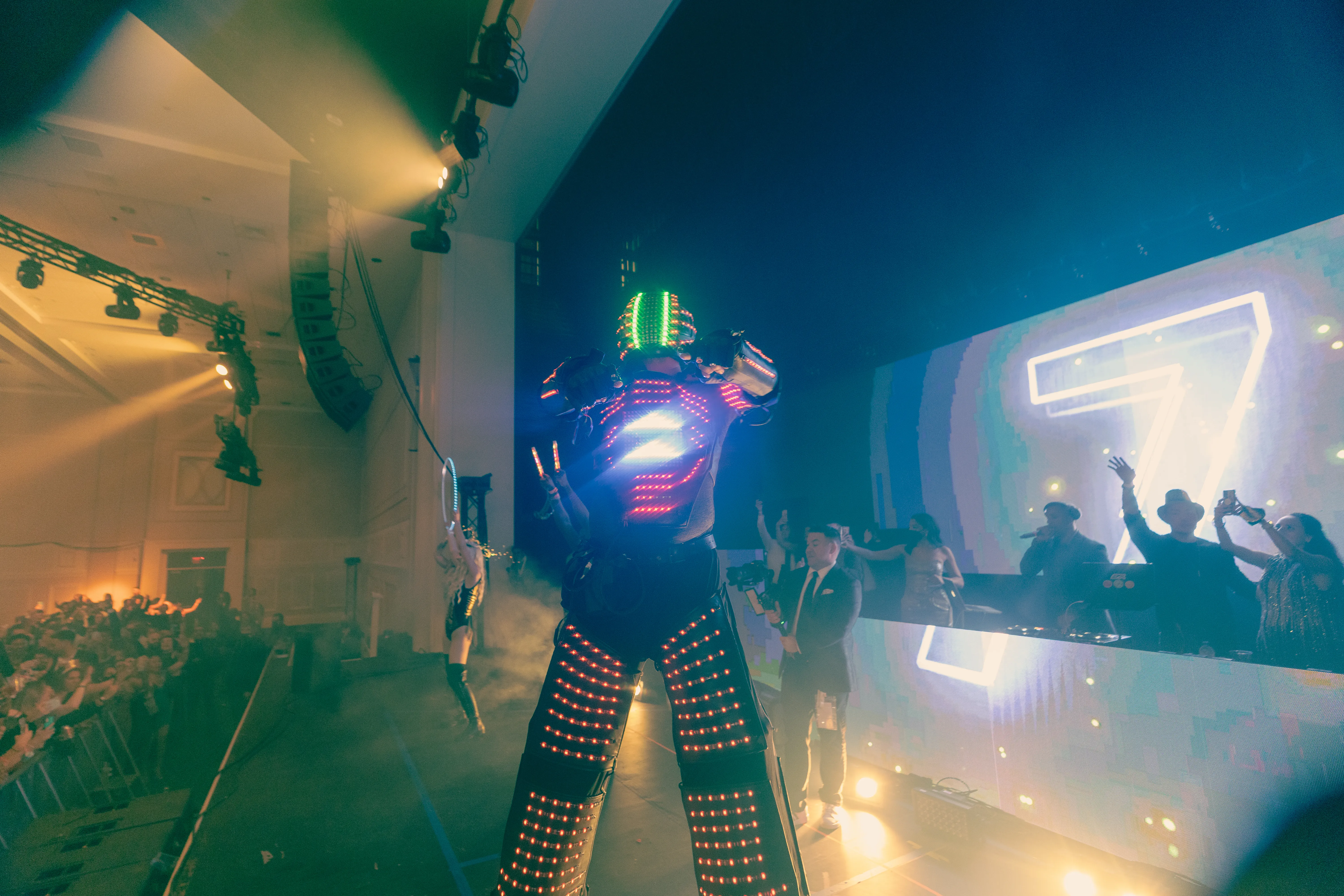 Big Night New Year’s Eve: an LED robot performer and an aerialist on stage as the video wall counts down to midnight