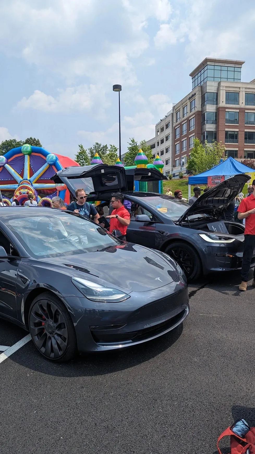National Ice Cream Fest at National Harbor, Md.: Tesla shows its cars, including a falcon-wing Model X, by the bounce houses