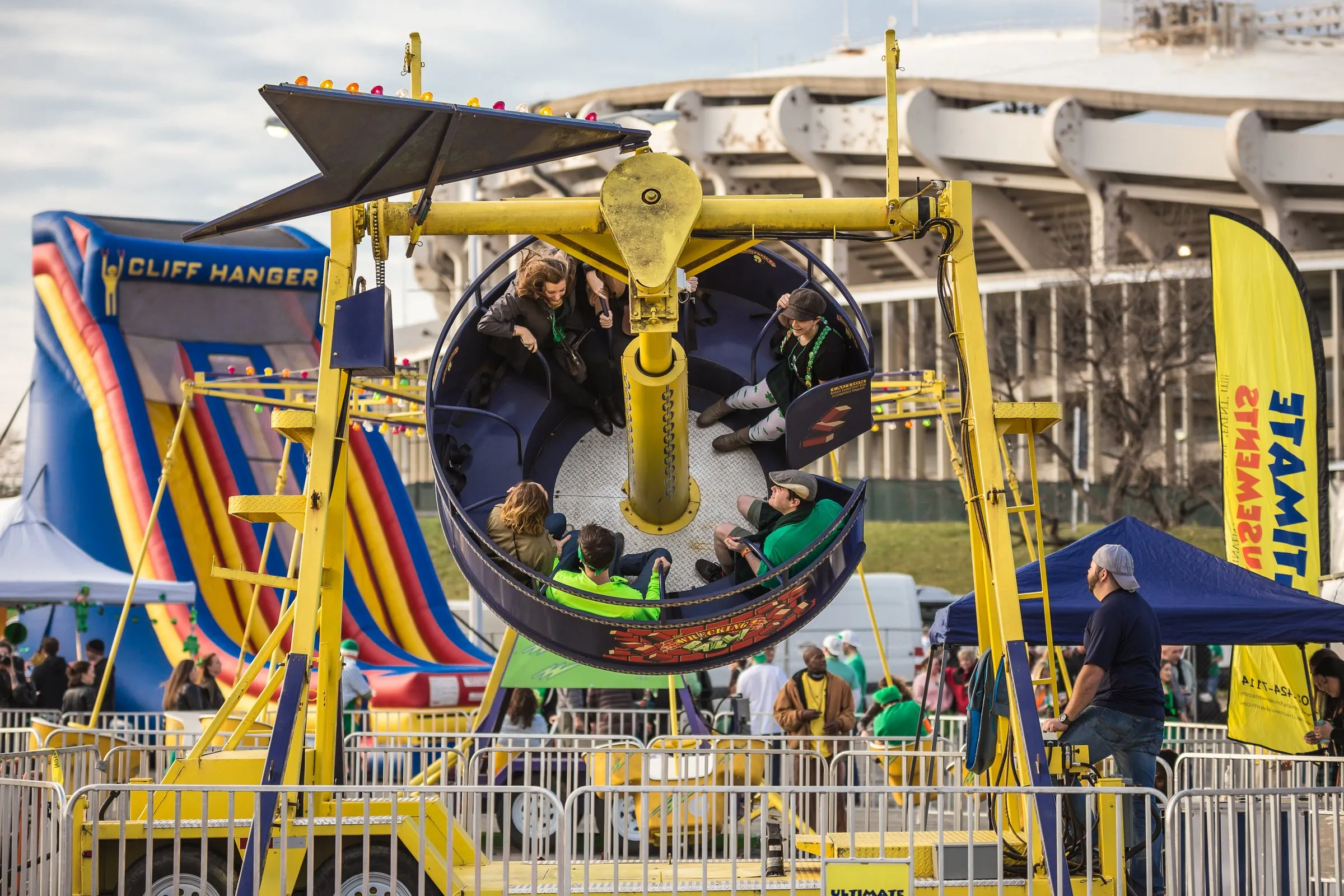 ShamrockFest festivalgoers in green ride a carnival ride outside RFK Stadium in Washington, D.C.